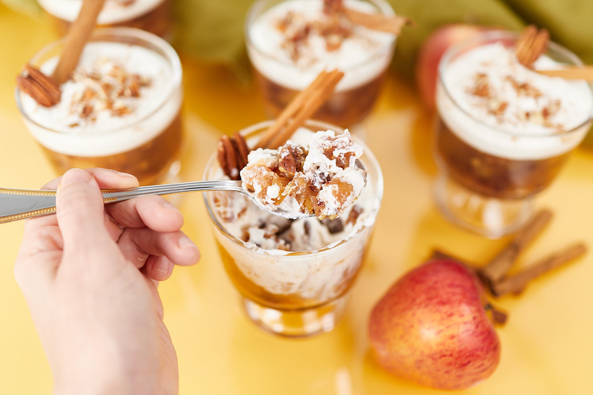 Apple cider salad on spoon with cream.