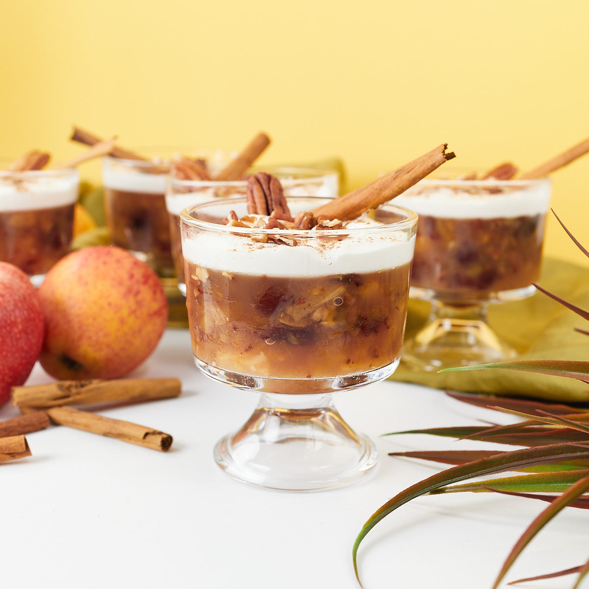 Apple cider salad with cranberries and pecans in dessert glasses.
