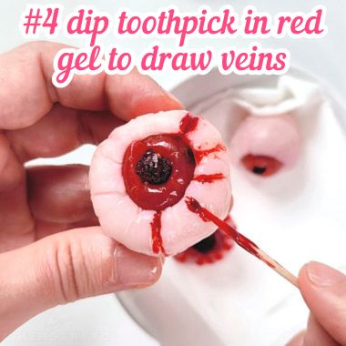 Drawing red veins in lychee eyeball with toothpick.