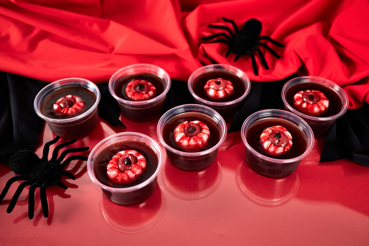 Red jello shots with lychee and cherry eyeballs.