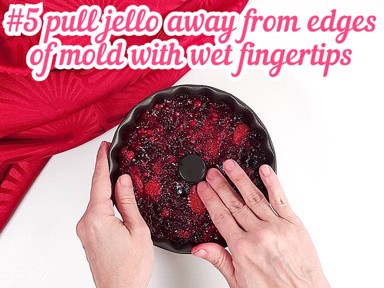 Pulling jello away from mold edges with fingertips.