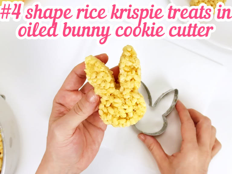Removing shaped rice krispie treat from bunny cookie cutter.
