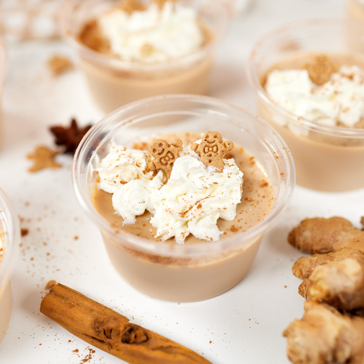 Gingerbread Fireball jello shot in plastic cup topped with whipped cream and cinnamon.