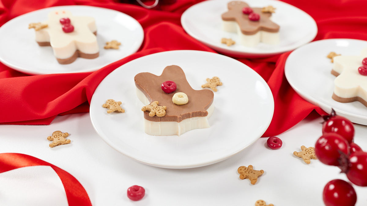 Gingerbread jello person with its head bitten off amidst cheerful holiday decorations.