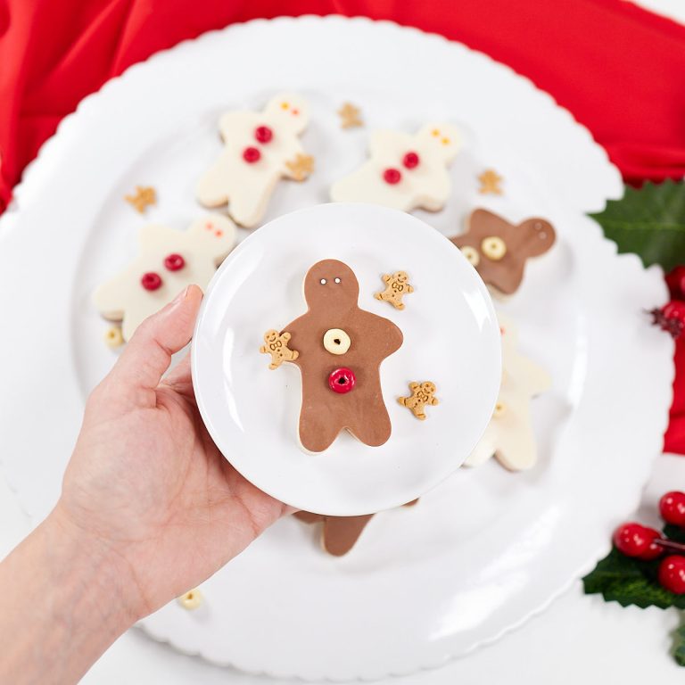 Gingerbread jello jigglers with sprinkles on a small plate.