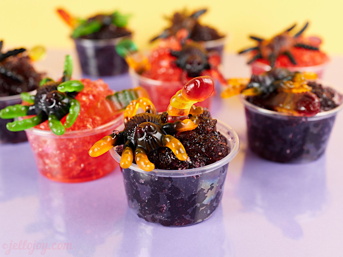 Gummy spiders in broken grape and strawberry jello.