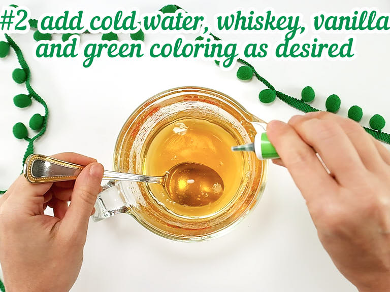Add cold water, whiskey, vanilla and green coloring.