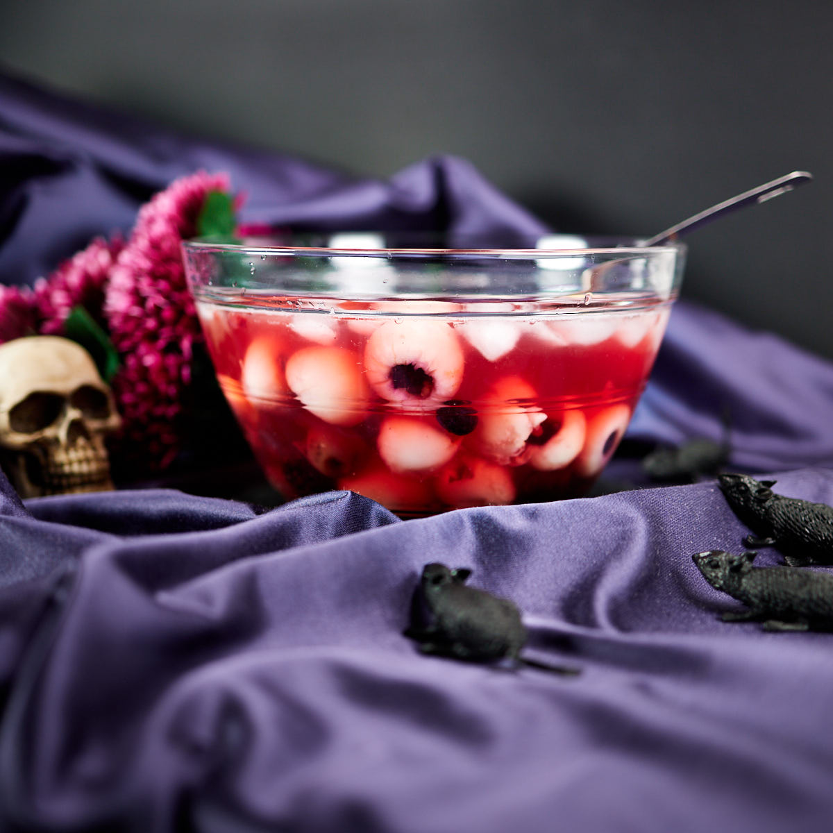 Halloween punch in a transparent punch bowl with floating eyes.