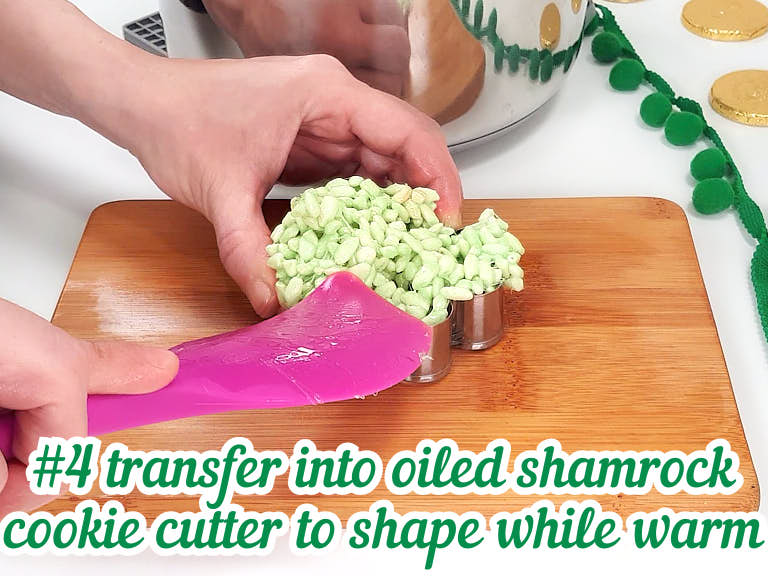 Placing rice krispie treat into cookie cutter with spatula.