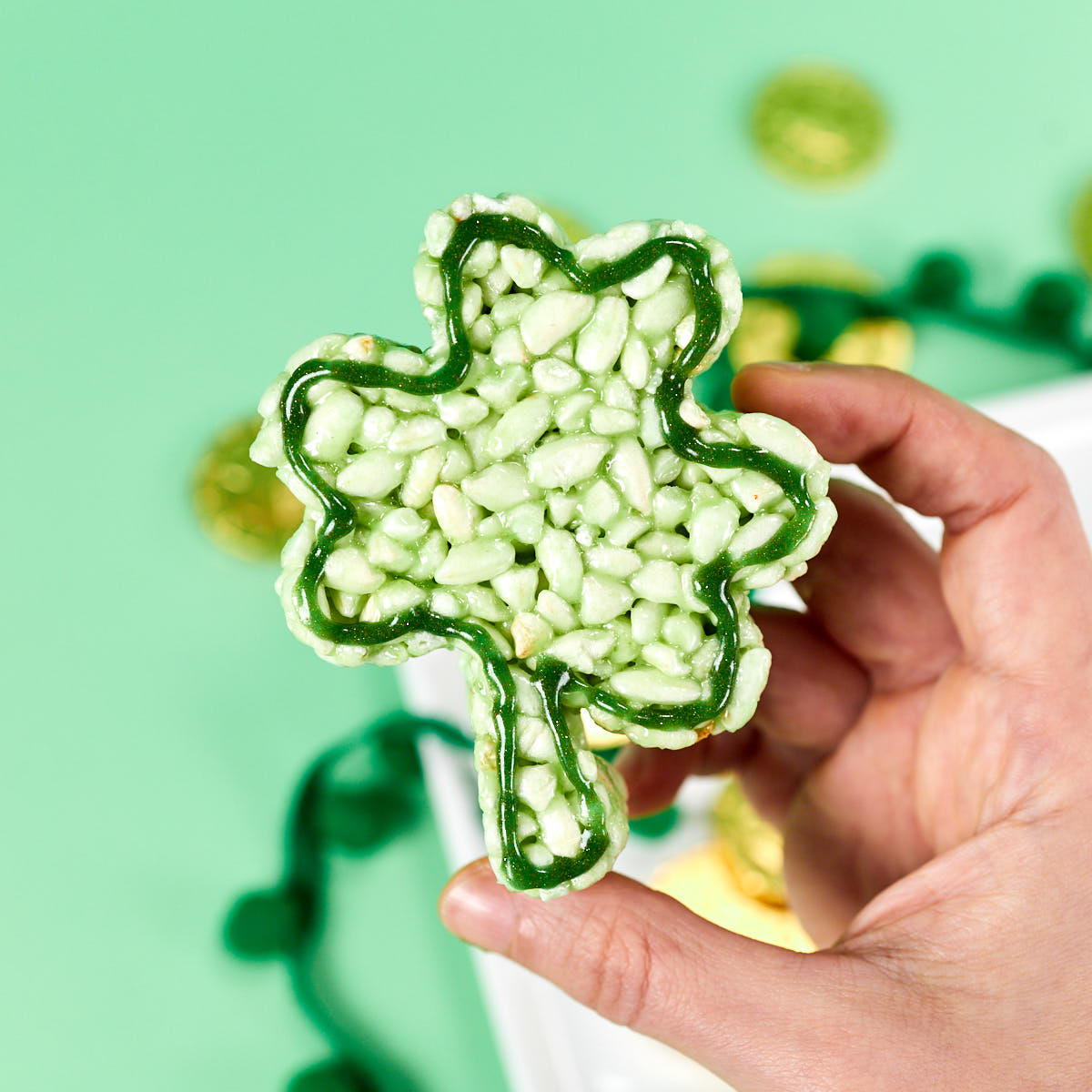 Shamrock rice krispie treat on hand.