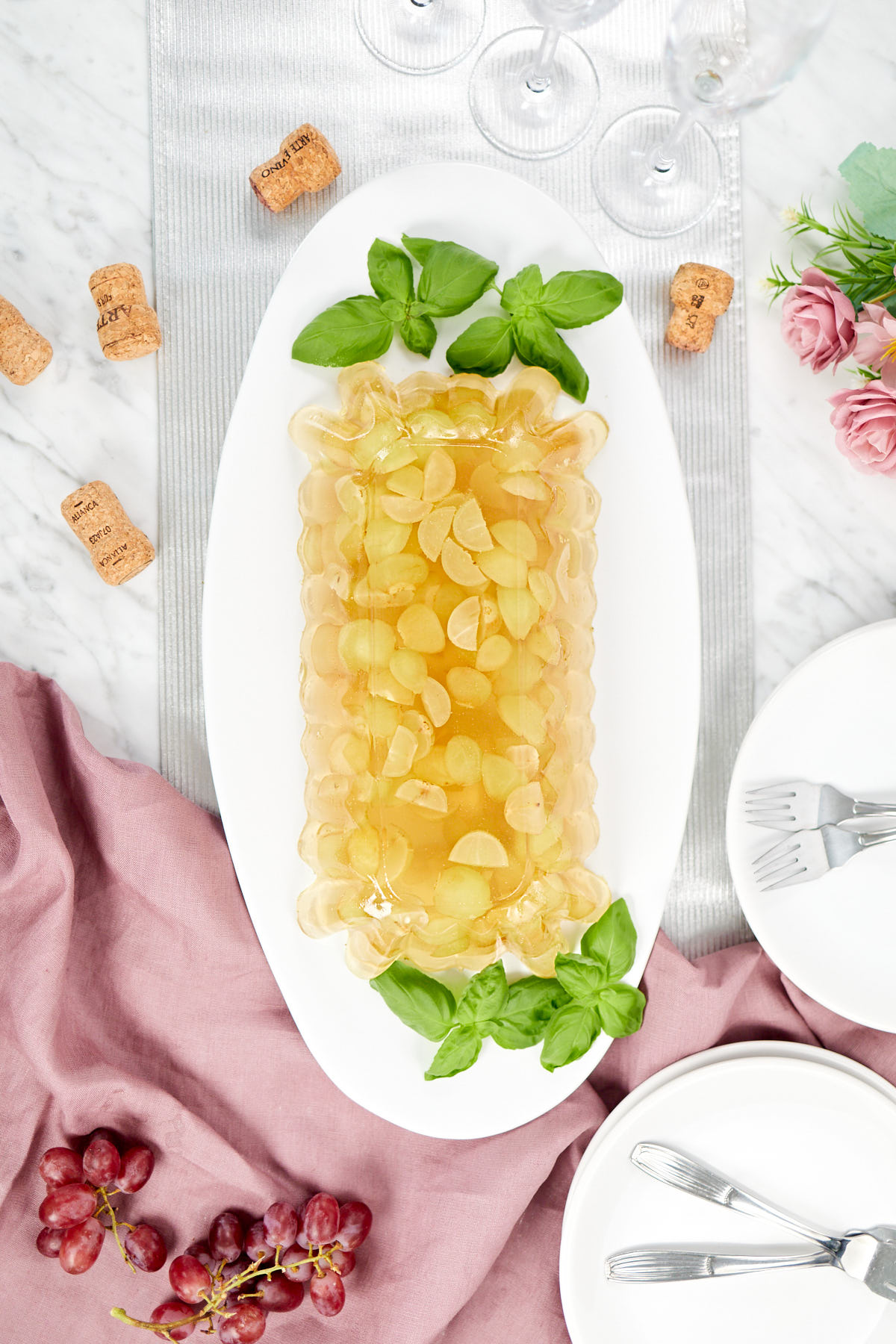 Sparkling white grape jello with Champagne on a festive table setting.