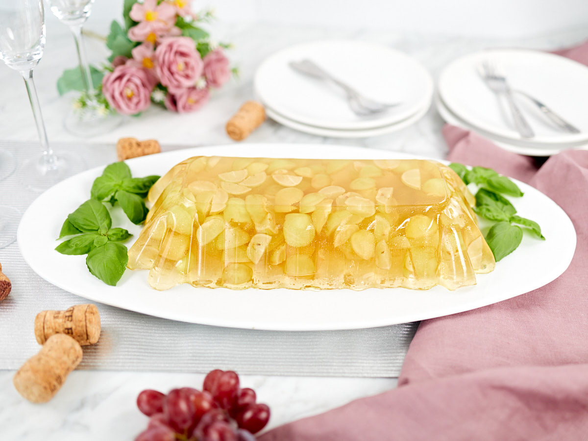 Grape and sparkling Champagne jello garnished with basil leaves.